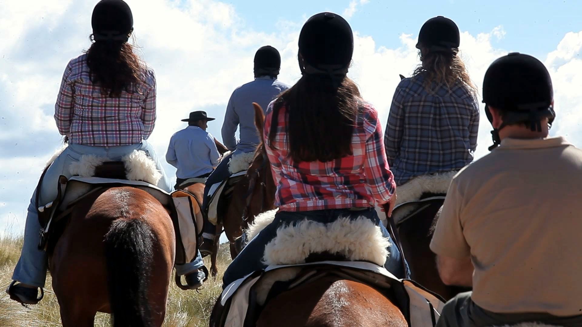 Riders on equestrian route wearing helmets on their heads.