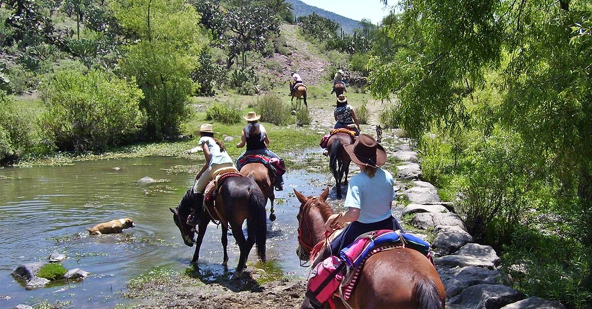 Crossing the river on horseback Mexico