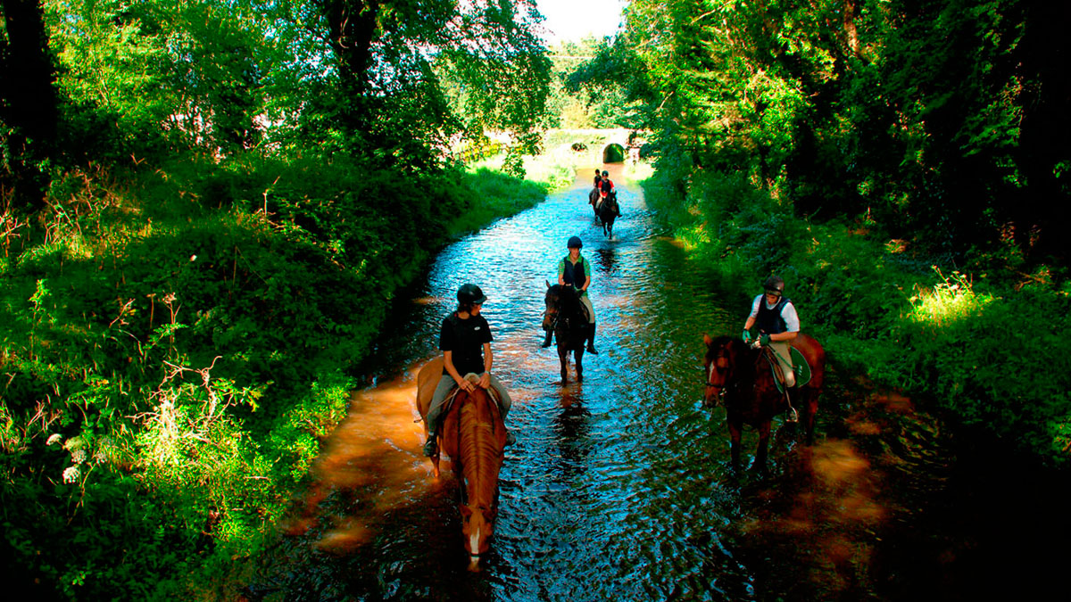 Crossing the river on horseback in Ireland